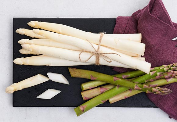 Abbildung: Grüner und weißer Spargel auf einem Brett
